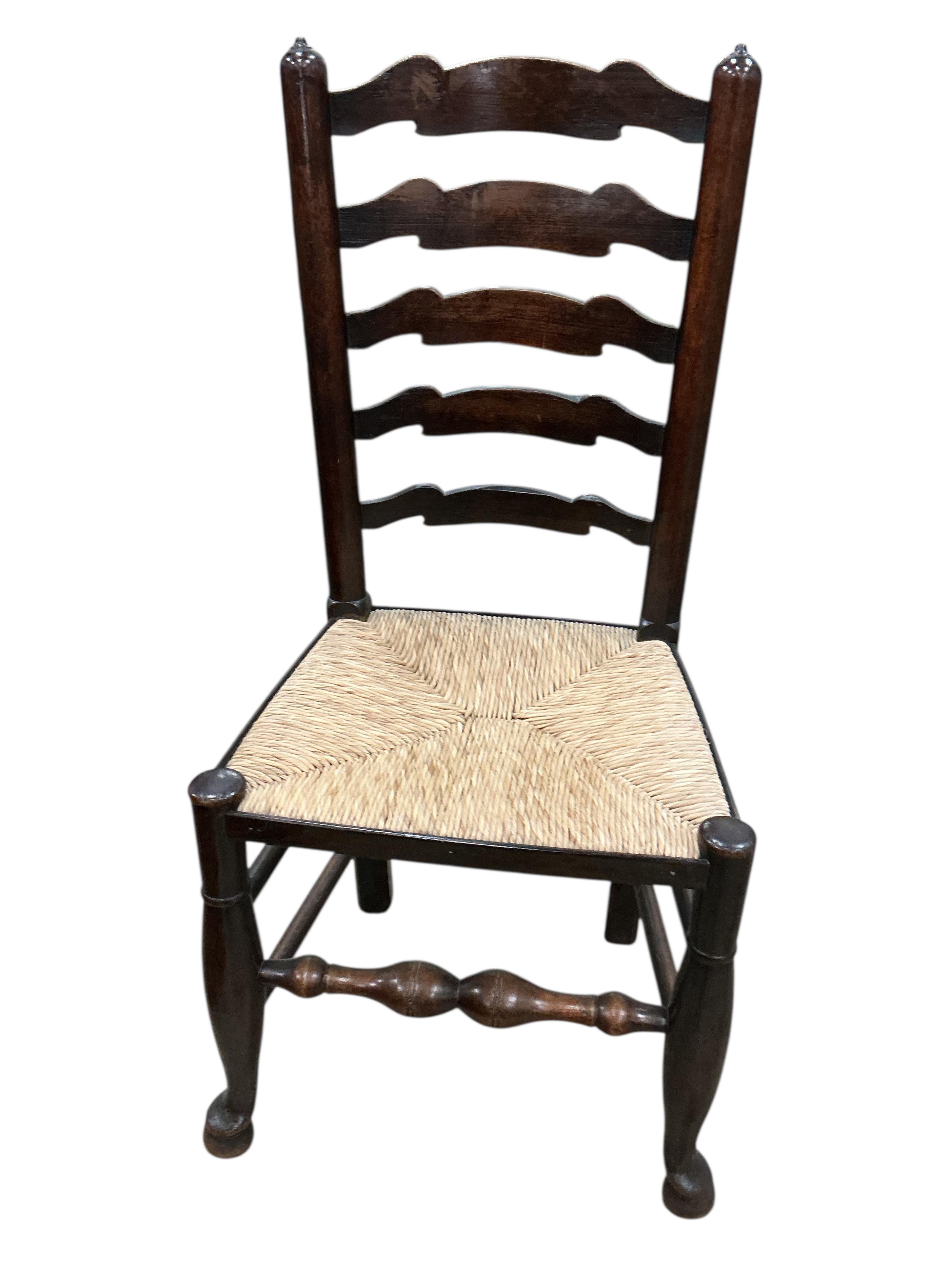 A set of eight 19th century Lancashire rush seat ash ladderback chairs, two with arms